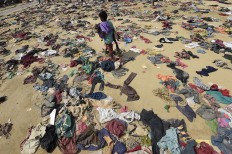 A Rohingya Muslim boy walks past discarded clothing on the ground at the Bhalukali refugee camp near Ukhia on September 16, 2017.
According to the UN nearly 400,000 Rohingya have arrived in Bangladesh since August 25 after fleeing a military crackdown launched by Myanmar's military in response to attacks by Rohingya rebels. AFP/ Dominique Faget 