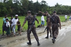 Bangladesh Border Guard (BGB) attempts to clear Rohingya Muslim refugees off a road near Balukhali refugee camp near the Bangladehsi district of Ukhia on September 19, 2017. Aung San Suu Kyi said September 19 she does not fear global scrutiny over the Rohingya crisis, pledging to hold rights violators to account but refusing to blame the military for violence that has driven some 421,000 of the Muslim minority out of her country. In an address timed to pre-empt likely censure of Myanmar at the UN General Assembly in New York -- delivered entirely in English and aimed squarely at an international audience -- she called for patience and understanding of the unfurling crisis in her "fragile democracy". AFP/ Dominique Faget 