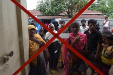 Rohingya Muslim refugees wait for a consultation outside a clinic run by the International Organisation for Migration (IOM) in Leda refugee camp near the Bangladeshi town of Teknaf on September 18, 2017. Pressure grew on Myanmar September 18 as a rights group urged world leaders to impose sanctions on its military, which is accused of driving out more than 410,000 Rohingya Muslims in an orchestrated "ethnic cleansing" campaign. The exodus of Rohingya refugees from mainly Buddhist Myanmar to neighbouring Bangladesh has sparked a humanitarian emergency. Aid groups are struggling to provide relief to a daily stream of new arrivals, more than half of whom are children. AFP/ Dominique Faget 