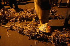 Simple tool: A decorated conical hat used as protective gear lies on dry banana tree fronds. JP/ Maksum Nur Fauzan