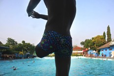A swimming athlete warms up prior to diving into the pristine pool at the NPC training center. JP/Maksum Nur Fauzan