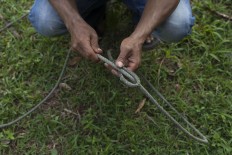 A man prepares a lasso before the match. JP/Sigit Pamungkas