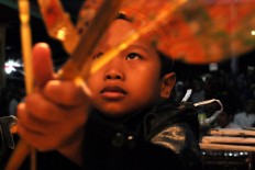 A young puppeteer performs during the Mount Merapi offering ritual. JP/Magnus Hendratmo