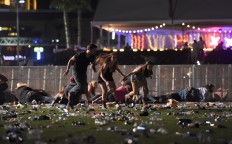 People run from the Route 91 Harvest country music festival after apparent gun fire was heard on October 1, 2017 in Las Vegas, Nevada. There are reports of an active shooter around the Mandalay Bay Resort and Casino.  AFP/Getty Images/David Becker