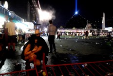 People take cover at the Route 91 Harvest country music festival after apparent gun fire was heard on October 1, 2017 in Las Vegas, Nevada. There are reports of an active shooter around the Mandalay Bay Resort and Casino.  AFP/Getty Images/David Becker