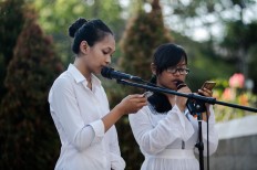 Wina (left) and Dinda (right) read a poem titled Surat Rindu Kami (Our Longing Letters) dedicated to their parents, who were killed in the bomb blasts. JP/Anggara Mahendra