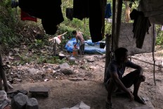 Gold miners take a bath using water from the gold mine. JP/ Magnus Hendratmo