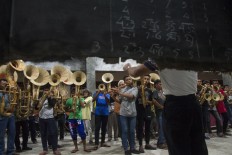 High and low: The music troupe in Sangihe, North Sulawesi, practices using a humble blackboard on which is written the musical score. JP/ Tarko Sudiarno
