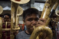 Whole-hearted: A boy blows into his tuba. Agustinus Sasundu's bamboo music troupe consists of musicians of all ages. JP/ Tarko Sudiarno
