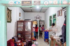 The family of Jamilah -- who has been living in the house since the 1990s -- is doing their daily routines inside the house. JP/Anggara Mahendra