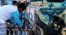 Reel deal: A competitor handles fishing equipment near a mural of Captain Jack Sparrow from the Pirates of the Carribean film series. JP/ PJ Leo
