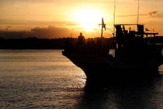 Enjoying the view: Sport fishing competitors sit on the deck of their ship during sunset. JP/ PJ Leo