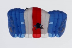  A parachuter flies over the Air Force base during the Air Show. JP/Arya Dipa