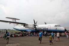Visitors are sitting beneath the wings of N-250 aircraft, which is produced by PT Dirgantara Indonesia, during the show. JP/Arya Dipa