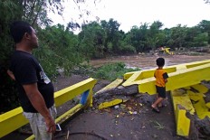 The remains of a bridge destroyed by flood waters in Blawong village in Jetis district, Bantul regency, on Nov. 28. Villagers have been forced to take a longer route to reach the other side of the river. JP/Aditya Sagita
