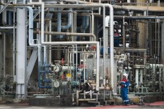 On duty: Two workers carry out maintenance work at the refinery. JP/ Jerry Adiguna