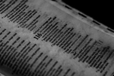 Calling to the Lord: A resident reads from the Book of Psalms in the Bible. JP/Seto Wardhana