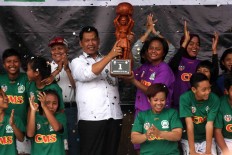 Members of Putri Mataram Yogyakarta celebrate at the trophy presentation. JP/Maksum Nur Fauzan