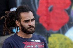 Suhaib Attar, a 25-year-old graffiti artist and student, looks on as he draws a mural on a wall in the Jordanian capital Amman on December 16, 2017. A tiny group of graffiti artists are on a mission -- daubing flowers, faces and patterns across the capital Amman to bring more colour to the lives of its four million inhabitants.
In a conservative society like Jordan's, the graffiti artists have constantly had to challenge convention to carve out a niche for their works, though still with limits as they steer away from politics and religion. AFP/Khalil Mazraawi  