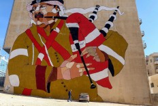 A picture taken on December 17, 2017 shows a graffiti mural on a wall in the Jordanian capital Amman. A tiny group of graffiti artists are on a mission -- daubing flowers, faces and patterns across the capital Amman to bring more colour to the lives of its four million inhabitants.
In a conservative society like Jordan's, the graffiti artists have constantly had to challenge convention to carve out a niche for their works, though still with limits as they steer away from politics and religion. AFP/Khalil Mazraawi  