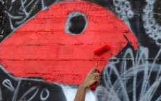 A picture taken on December 16, 2017 shows a graffiti artist drawing a mural in the Jordanian capital Amman. A tiny group of graffiti artists are on a mission -- daubing flowers, faces and patterns across the capital Amman to bring more colour to the lives of its four million inhabitants.
In a conservative society like Jordan's, the graffiti artists have constantly had to challenge convention to carve out a niche for their works, though still with limits as they steer away from politics and religion. AFP/Khalil Mazraawi 