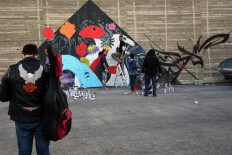 A picture taken on December 16, 2017 shows graffiti artists drawing a mural in the Jordanian capital Amman. A tiny group of graffiti artists are on a mission -- daubing flowers, faces and patterns across the capital Amman to bring more colour to the lives of its four million inhabitants.
In a conservative society like Jordan's, the graffiti artists have constantly had to challenge convention to carve out a niche for their works, though still with limits as they steer away from politics and religion. AFP/Khalil Mazraawi