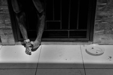 A mentally ill patient rests his feet through the bars of his isolation room in the Galuh Foundation rehabilitation center in Bekasi, West Java. Antara/Hafidz Mubarak