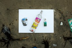 Wasted: Wine bottles that washed up on Kuta Beach. JP/Agung Parameswara.