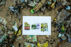 Leftovers: Empty snack packets and a bottle of milk that were found on Jimbaran Beach in Bali. JP/Agung Parameswara.