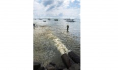 Dark waters: Liquid waste from nearby factories and companies directly goes directly into the ocean. JP/ Tarko Sudiarno