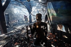 A fire fighter puts out fires among the debris inside the 17th century Dutch colonial building that houses the Maritime Museum in Penjaringan, North Jakarta on Tuesday January.16. Although the blaze destroyed the museum's collection, including dioramas and historic maps, no casualties were reported from the incidents. JP /Jerry Adiguna