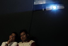 Visually impaired men, accompanied by volunteers, attend the Blind Date Cinema event at Paviliun 18 in South Jakarta on Sunday January.14. The event was held to give those with visual impairments the opportunity to experience a movie. JP/Seto Wardhana