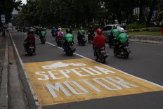 Motorcyclists drive outside a lane dedicated to motorcycles on Jl. Medan Merdeka Barat in Central Jakarta on Tuesday, January.16. JP/P.J.Leo
