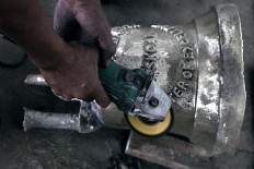 A bell is stamped with the identity of the customer and the year of its manufacturing. JP/Magnus Hendratmo