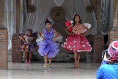 Young girls showcase clothes made of plastic during the festival. JP/Magnus Hendratmo