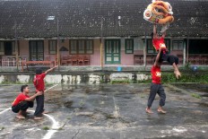 Practice: Two pairs of barongsai dancers practice their routines. JP/ Maksum Nur Fauzan