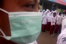 Surgical masks for students and teachers are provided by the school.  JP/Maksum Nur Fauzan