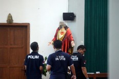 Beheaded: Police officers inspect the statue of Jesus at St. Lidwina Church in Bedog, Sleman, Yogyakarta on Sunday, February 11. A man attacked the church using a sword during mass, injuring several people, including the pastor. JP/Aditya Sagita