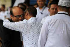 Welcome back: A colleague hugs Corruption Eradication Commission (KPK) senior investigator Novel Baswedan at the KPK office in Jakarta after arriving from Singapore on Thursday, February 22.