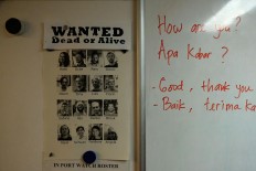 Inside peek: A poster shows the Rainbow Warrior crew beside tips for learning simple greetings in Indonesia. JP/Jerry Adiguna
