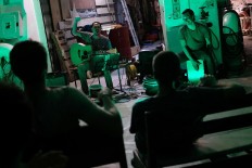 Light moment: The crew watches a music performance by Indonesian musician Robi Navikula on board the ship in Sorong waters in Papua. JP/Jerry Adiguna