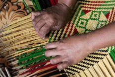 Community living: Workers weave bamboo sheets in Umasendi hamlet, Tigawasa village. JP/Agung Parameswara