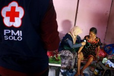 A doctor examines an elderly patient. JP/Maksum Nur Fauzan