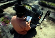 A man prays for his deceased family members. JP/Boy T. Harjanto