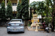 A spirit house is located at the parking lot of an inn in Chiang Mai, Thailand. JP/Anggara Mahendra