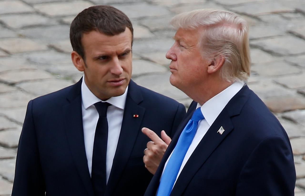 French President Emmanuel Macron and U.S. President Donald Trump walk in the courtyard as they leave after a welcoming ceremony at the Invalides in Paris, France, July 13, 2017. 