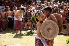 One on one: Tengananese boys fight each other using thorny pandan leaves during Mekare-kare. JP/Agung Parameswara