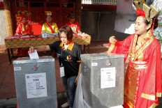 Polling station officials in Cibadak subdistrict, Astana Anyar district, Bandung, are wearing Chinese royal costumes on voting day on Wednesday, June 27, 2018. JP/Arya Dipa