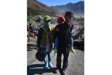 Bonding time: Supandi (right), a local shaman attends the Yadnya Kasada with his family. JP/ Aman Rochman