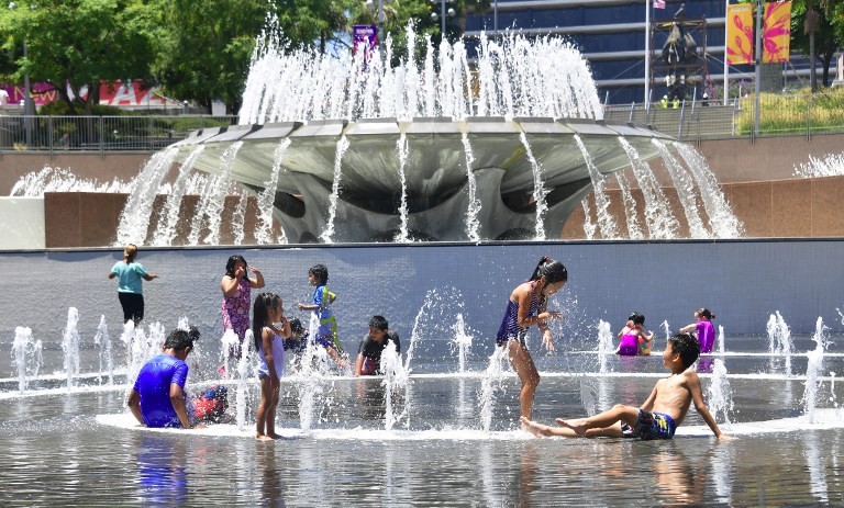 Children cool off in the water play area at Grand Park in Los Angeles, California on July 5, 2018 ahead of a coming heatwave in the Los Angeles area. 